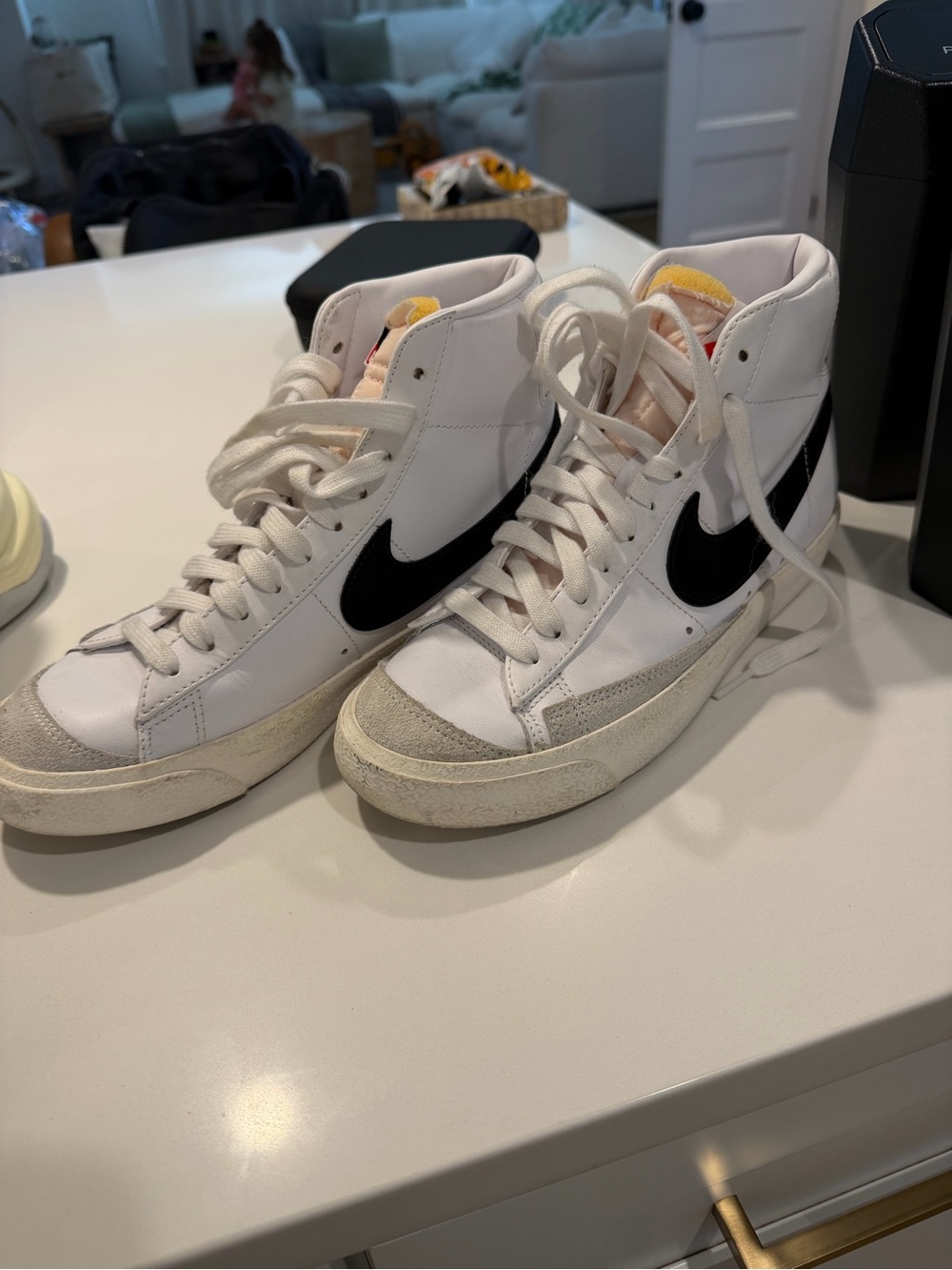Nike White High-Top Sneakers with Black Swoosh and Yellow Tongue